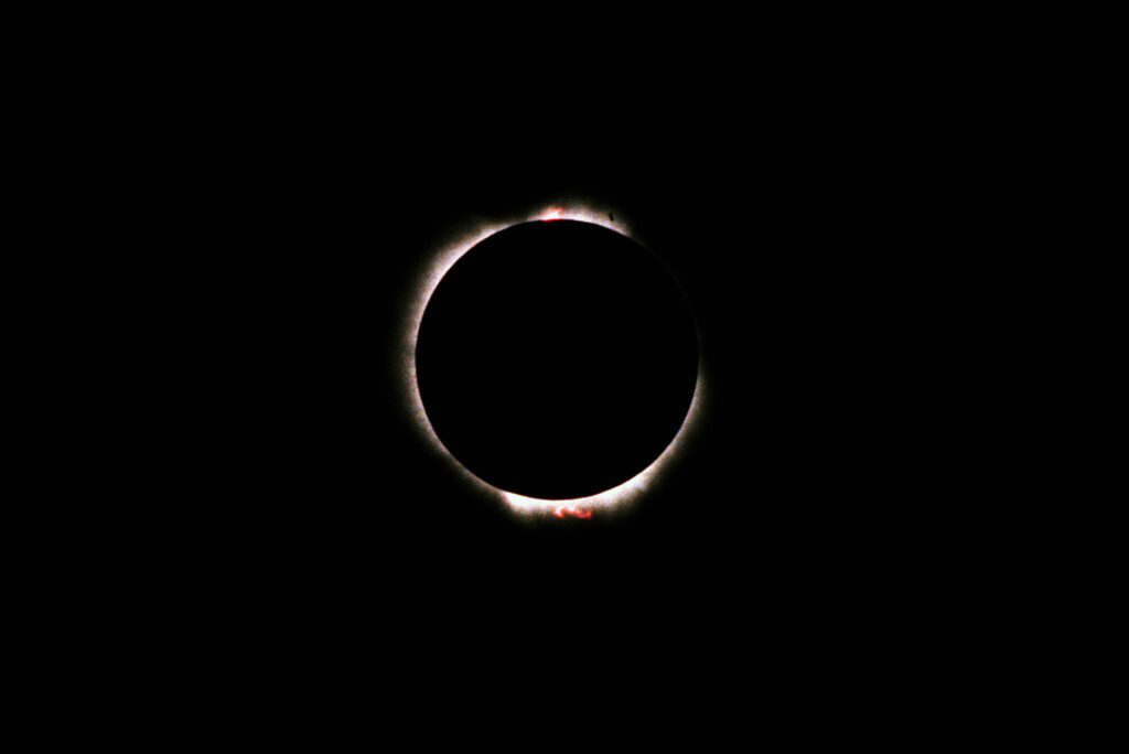 Total solar eclipse with sun's corona visible.