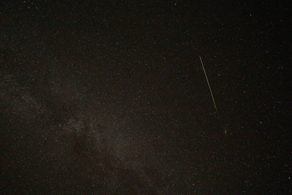 Night sky with shooting star and Milky Way.