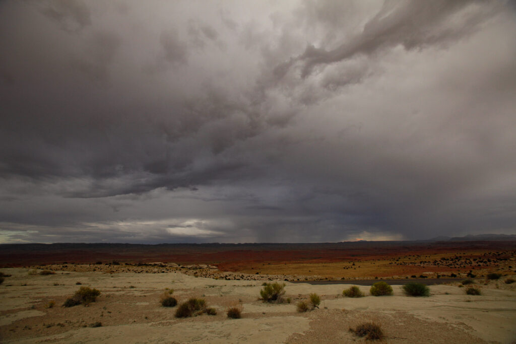 Dark storm clouds over desert landscape