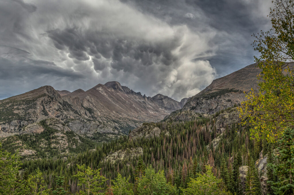 Rocky Mountain peaks and dramatic sky clouds.