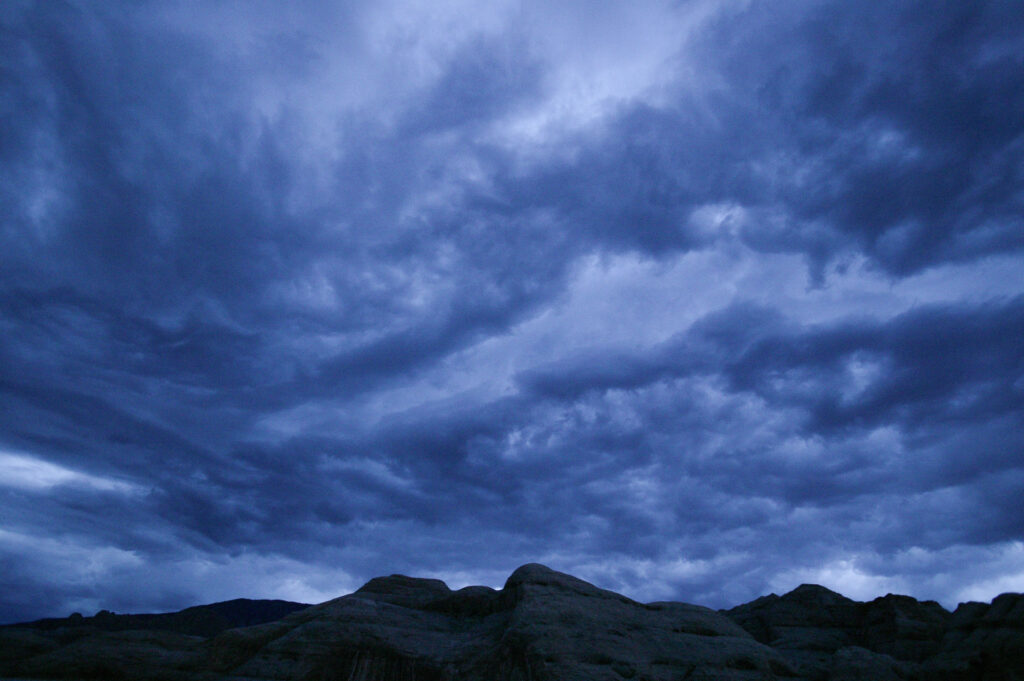 Dark storm clouds over rocky landscape