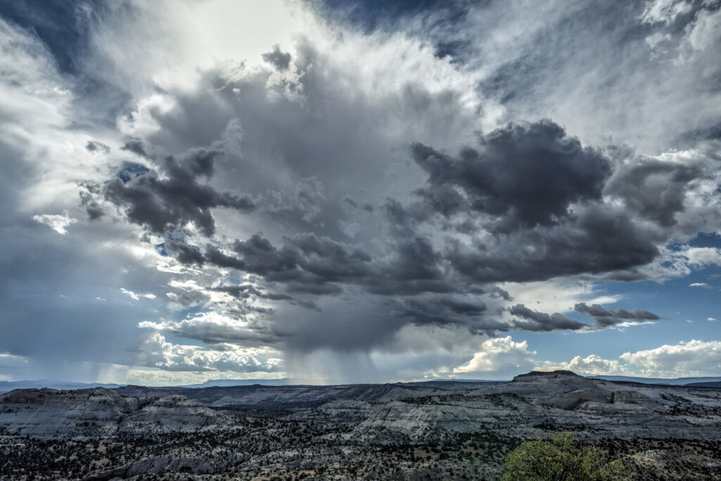 Dramatic clouds over rocky landscape.