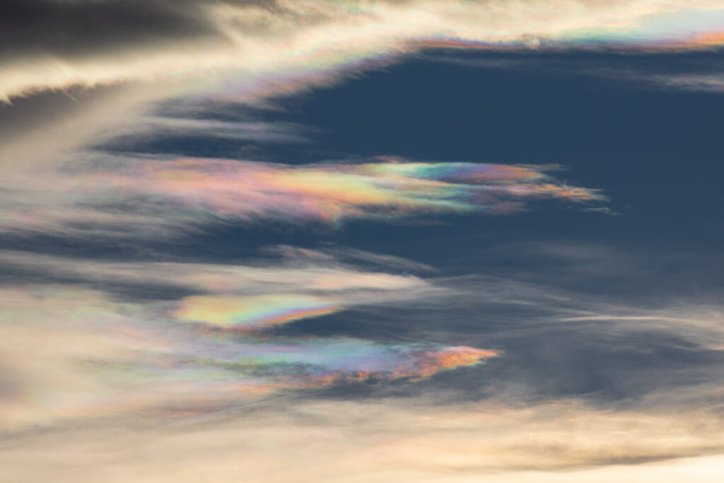 Sky with iridescent clouds and blue background.
